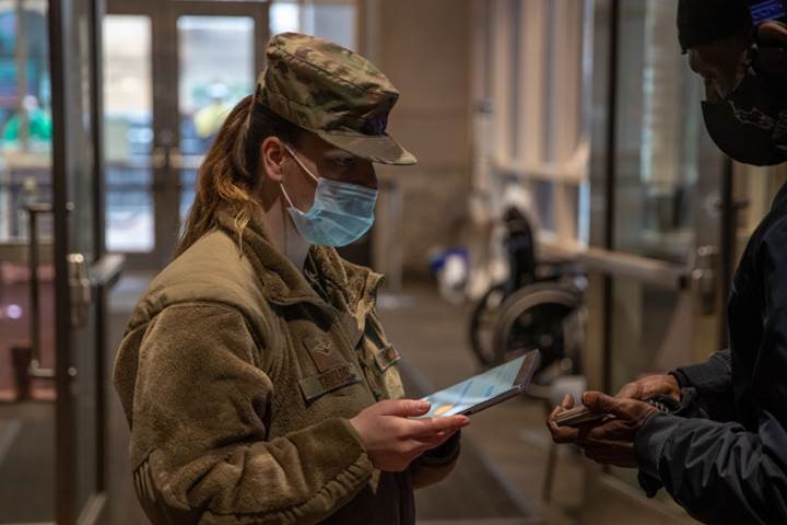Airman 1st Class, Mackenzie Taylor, a native of Milton, Pennsylvania, with the Pennsylvania National Guard, registers a community member for a COVID-19 vaccine at the federally-supported Center City Community Vaccination Center in the Pennsylvania Convention Center in Philadelphia on March 17, 2021.
