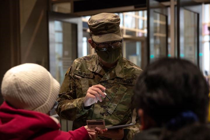 Army Specialist Grant Wagner, a native of Marysville, Pennsylvania, with the Pennsylvania National Guard, registers a community member for a COVID-19 vaccine at the federally supported Center City Community Vaccination Center in the Pennsylvania Convention Center in Philadelphia on March 17, 2021.