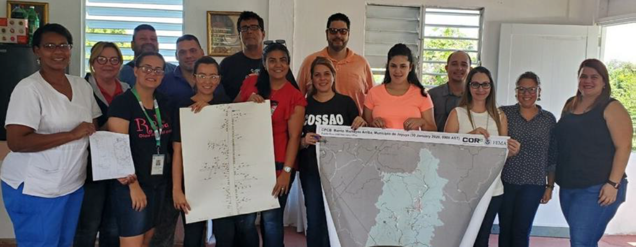 The community organization, COSSAO, proudly displays their maps. Shown from left to right – (left) the only map the community originally had access to, (middle) the map the community built after initial technical assistance, and (right) the final map the community received at the conclusion of the CPCB workshops.
