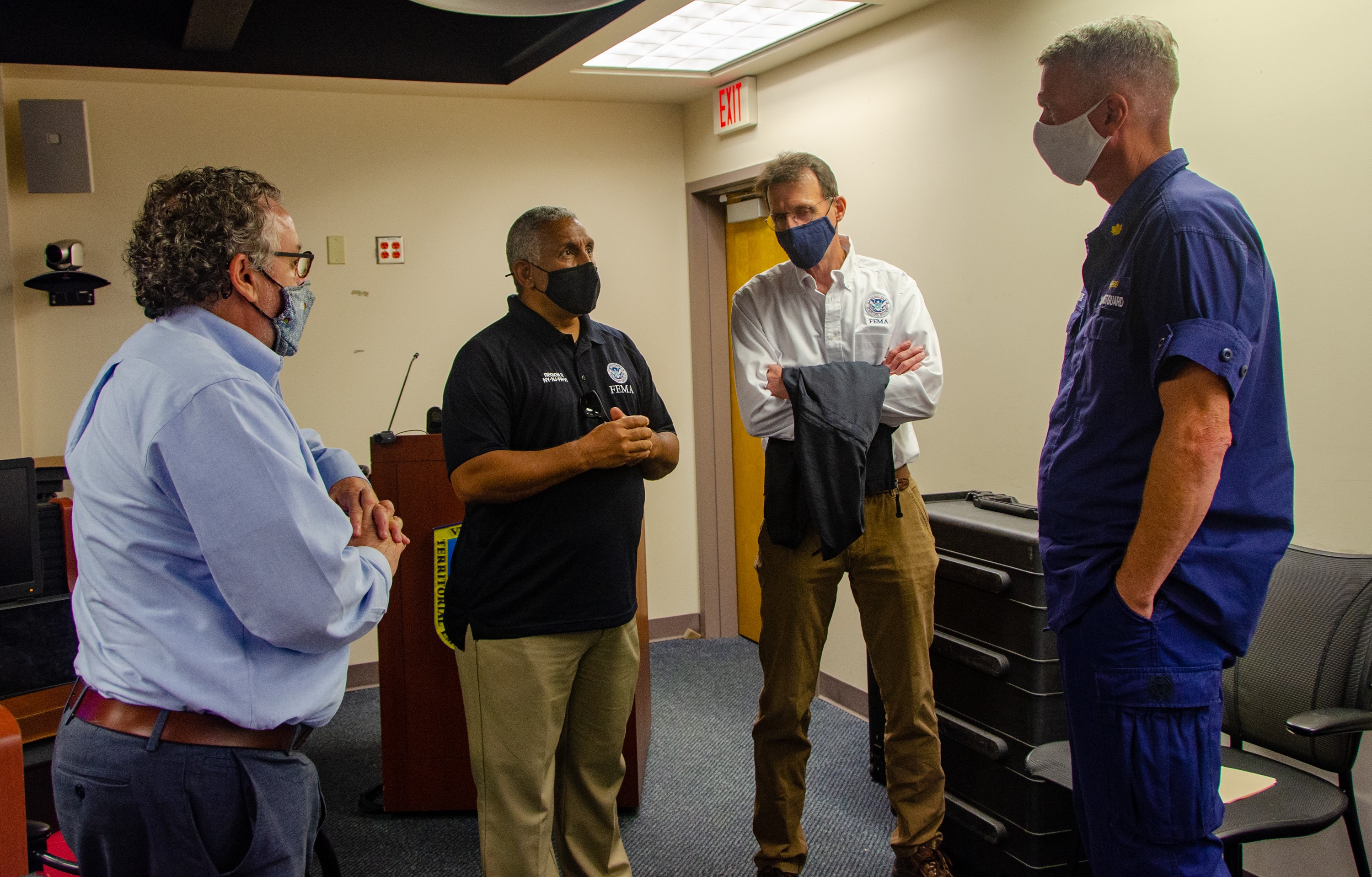  Region 2 Preparedness Division Director Russell Fox, (from left), U.S. Virgin Islands Caribbean Area Office Coordinator Mark A. Walters, Region 2 Acting Administrator Thomas Fargione and U.S. Coast Guard Lt. Cmdr. JJ League discuss hurricane preparedness for maritime operations during an Emergency Management Council Meeting at the V.I. Territorial Emergency Management Agency's Emergency Operations Center.  
