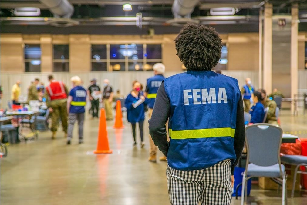 FEMA working standing in a Vaccinations Center