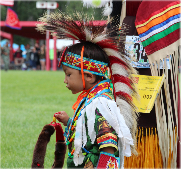 A child wearing traditional tribal head gear