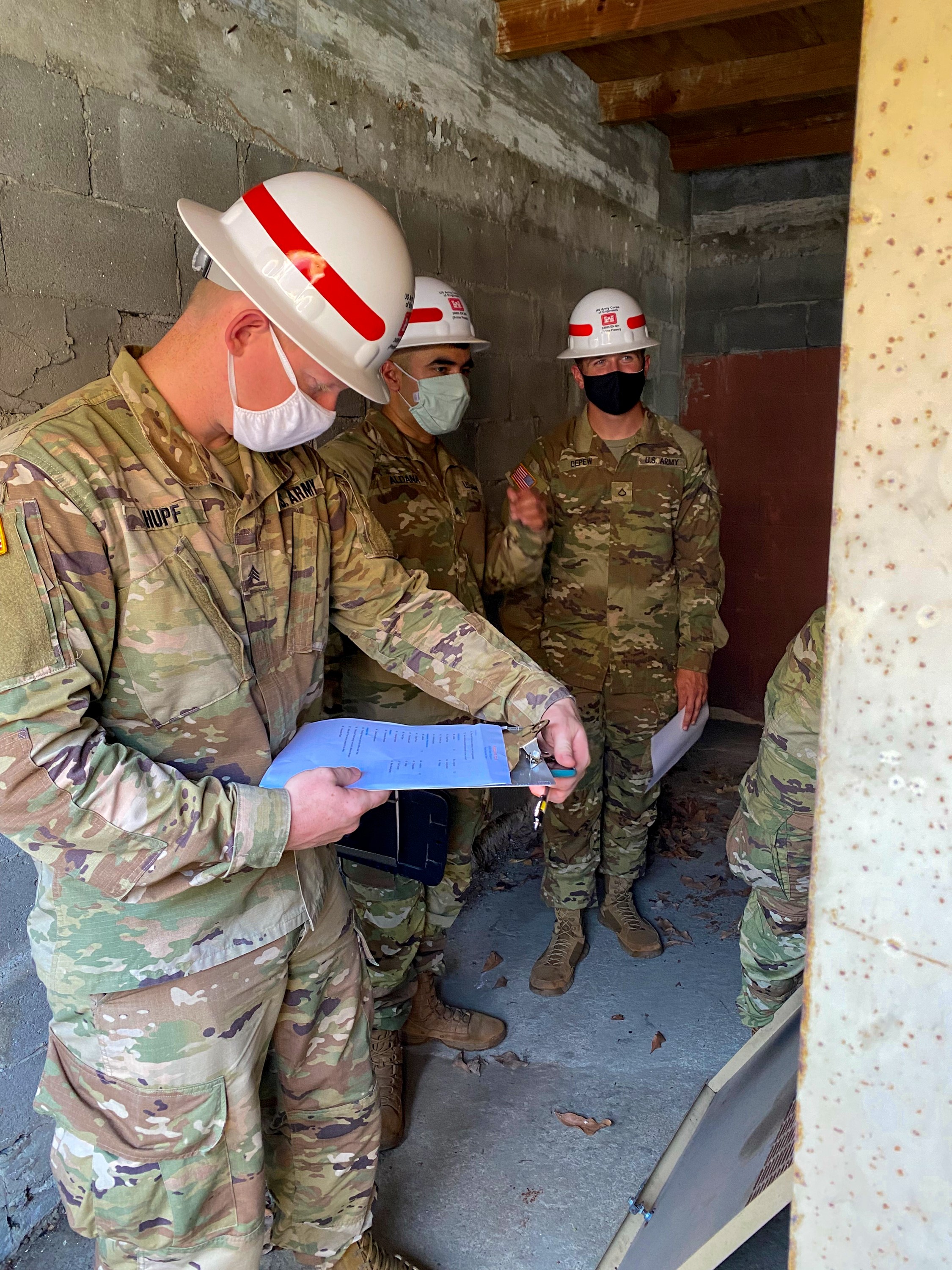 Sgt. Drake Hupf, (from left), Sgt. Joe Aldana and Pvt. Cameron Depew, of the Alpha Company of the 249th Engineer Battalion of the U.S Army Corps of Engineers, conduct an electrical assessment of a critical facility on St. Croix during their training mission.