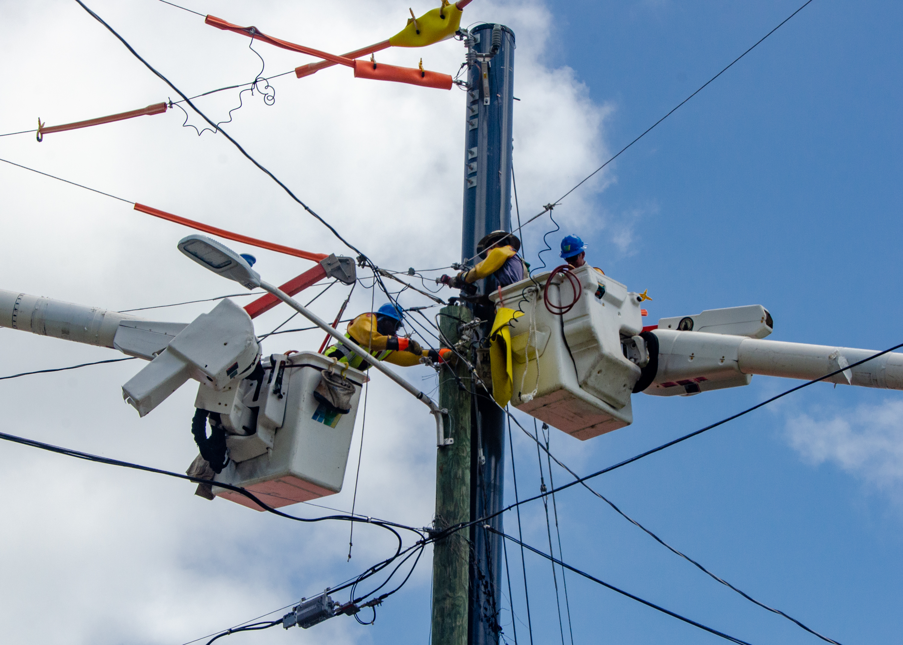 Haugland Virgin Islands line workers finish installation of a composite power pole in July 2021 in Upper Contant on St. Thomas. The Virgin Islands Water and Power Authority is leading operations to install 2,333 composite poles on the island
