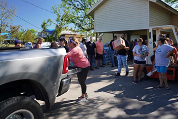Members of the Pointe-au-Chien Tribe, including its Tribal Council, and staff of the Houston Rockets basketball team help distribute donations of water, food and cleaning supplies to those impacted by Hurricane Ida in Montegut, a city in Terrebonne Parish