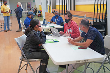FEMA specialists at a temporary Disaster Recovery Center (DRC) at the Milne Recreation Center fill out applications, provide status updates and answer inquiries for survivors who were impacted by Hurricane Ida. 