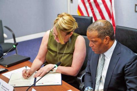 Caption:  FEMA Administrator Deanne Criswell and&nbsp;Founder and CEO of Operation HOPE&nbsp;John Hope Bryant sign an agreement for further partnership. 