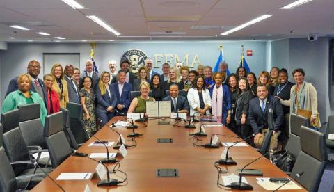 Caption: FEMA Administrator Deanne Criswell and Founder and CEO of Operation HOPE John Hope Bryant (center) along with representatives from FEMA and Operation HOPE following the agreement signing.