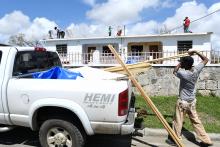 Men work on a roof 