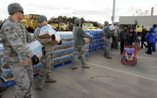 New York residents pick up water from the National Guard after Hurricane Sandy. 