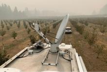 A FEMA Incident Response Vehicle provides communication support for urban search and rescue efforts from a burned-out orchard in the hills east of Springfield, Oregon