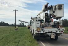 line crews replace a power pole to restore power in alabama