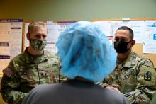 A doctor talking to two soldiers