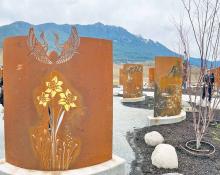 Flowers painted on curved metal in a memorial garden.