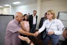 FEMA Administrator Deanne Criswell shacking hands with a faith-based community male leader