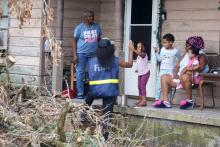 Members of a FEMA Disaster Survivor Assistance crew walk door to door to help residents of Houma apply for assistance after Hurricane Ida.