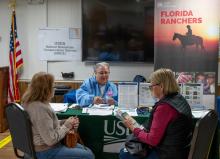 Disaster survivors stop by a USDA table to obtain information on the recovery process. 