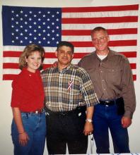 Sept. 14, 2001. Robert A. (Bob) Weaver (middle), U.S. Secret Service Agent from New York asked Lisa Nine (left) to hang up the American Flag when they first opened the re-located office from World Trade Center 7 to the John Jay College of Criminal Justice in New York City.