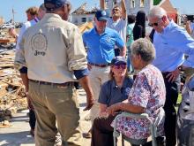 DHS Secretary Alejandro Mayorkas, FEMA Administrator Deanne Criswell and other emergency management officials speak with a survivor of the devastating tornadoes that impacted Mississippi. (FEMA photo)