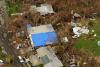  A blue tarp covers a house 