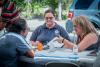  Two female FEMA specialists talk with a man 